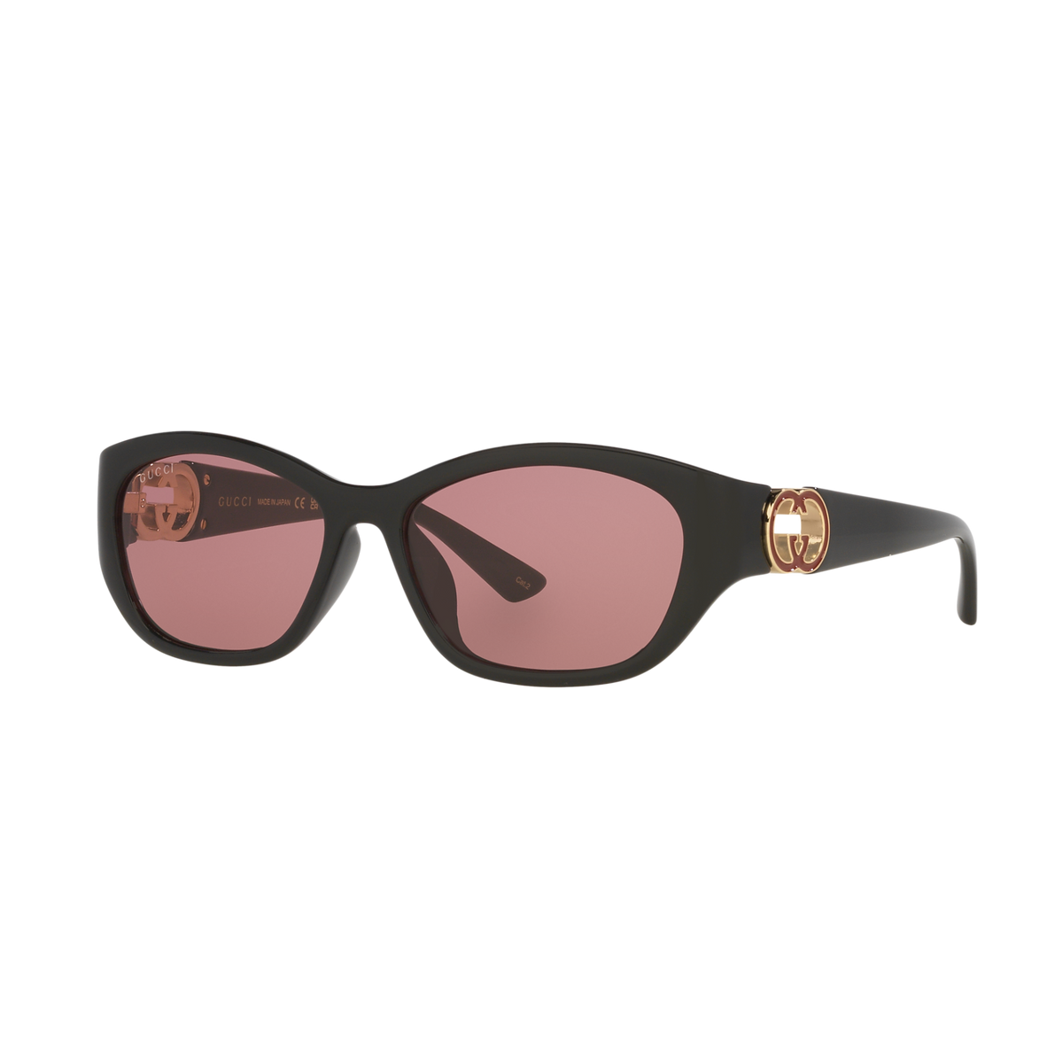 Black oversized luxury sunglasses with pink lenses and gold logo detail.